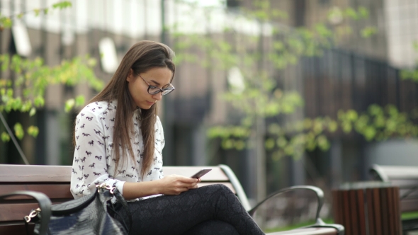 Elegant Young Girl Using The Black Tablet. Beautiful Student In Glasses
