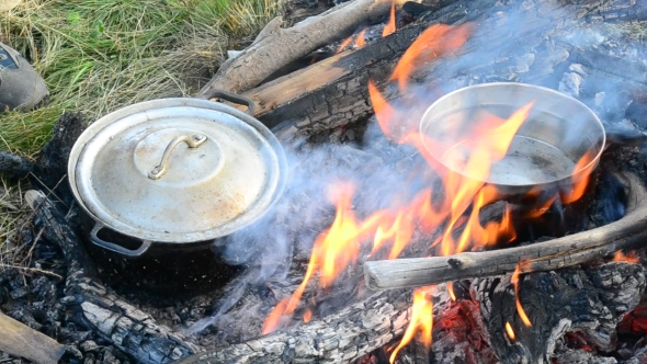 Cooking On Open Fire With Wooden Logs