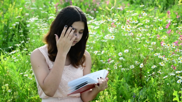 Dark-haired Girl Reading a Book On Nature