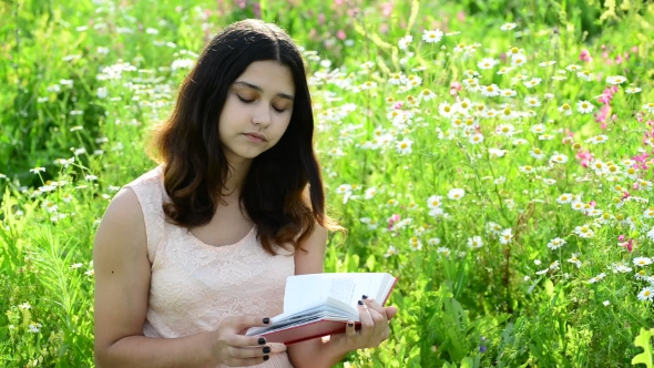 Dark-haired Girl Reading a Book On Nature