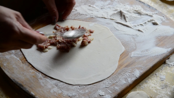 Housewife Making Chebureks From Dough And Sausage Meat