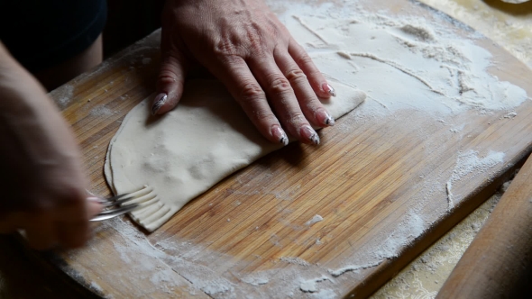 Housewife Making Chebureks From Dough and Sausage Meat