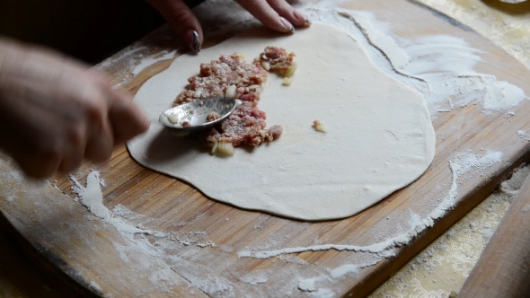 Housewife Making Chebureks From Dough And Sausage Meat