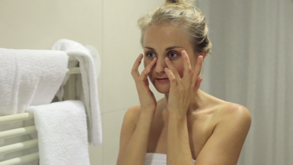 Woman Massaging Her Face alt