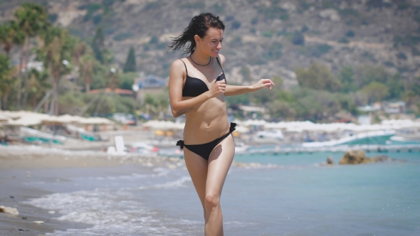 A Beautiful Young Woman Running At a Beach In Cyprus. alt