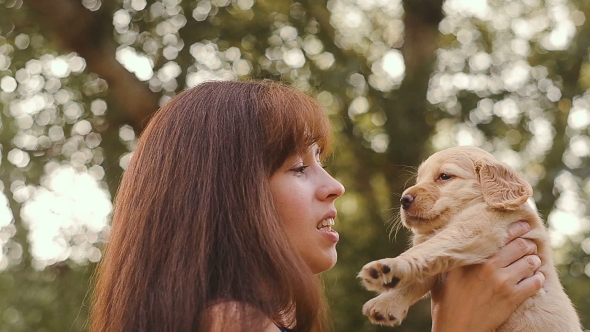 The Girl Embraces a Little Puppy alt