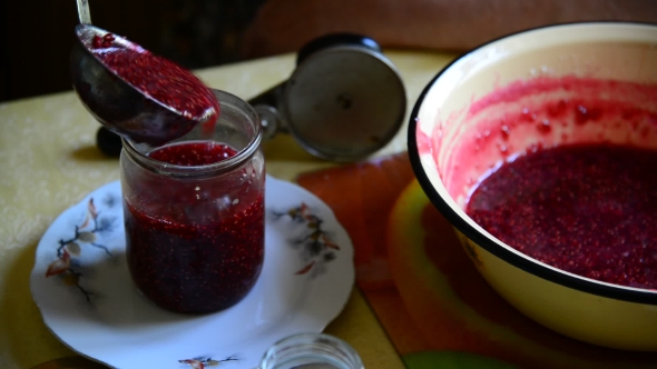 Woman Puts Handmade Raspberry Jam In Jar