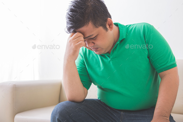 overweight man depress thinking about his weight problem