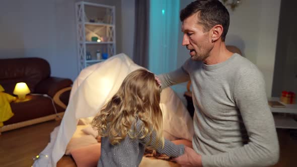 Handsome Father Spinning Cute Little Daughter Dancing in Living Room at Home alt