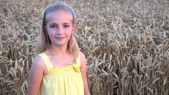 Cute Girl In Wheat Field