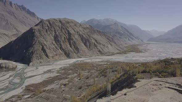Aerial View Of Skardu Rugged Valley Landscape With River Flowing Through. Dolly Forward alt