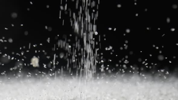 Particles of White Dry Sand Pour in Stream Hit the Surface and Scatter in Different Directions on an alt