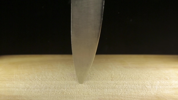 Large Sharp Knife Stuck In Wooden Desk