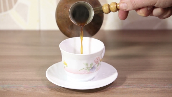 Woman Pouring Milk To Cup Of Espresso Coffee. 