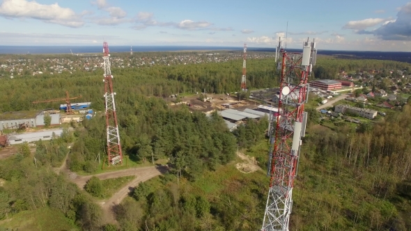 Aerial View Of Antenna Telecommunication Tower among other towers in the forest alt