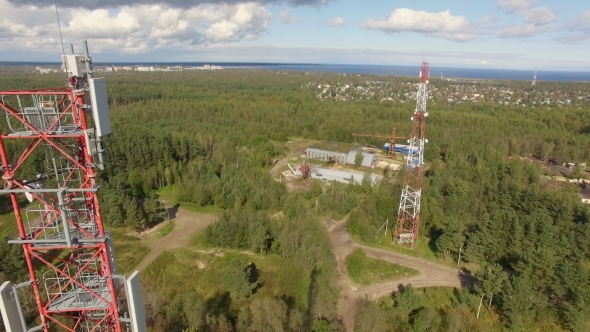 Aerial view of a telecommunication cell phone tower standing in the forest