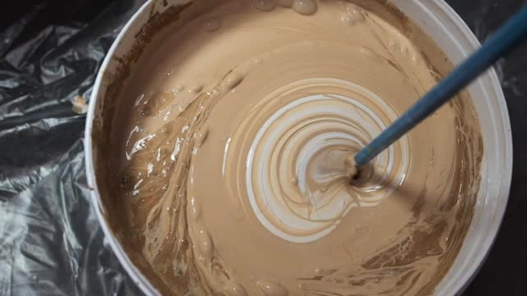 The Process Of Mixing White Paint With A Color Tinge In Bucket The Process Of Mixing White Paint With A Color Tinge In Bucket Drill Special Nozzle Stock Footage