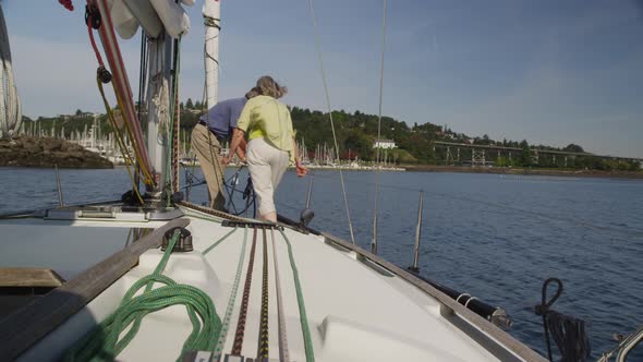 Senior couple on sailboat together. Shot on RED EPIC for high quality 4K, UHD, Ultra HD resolution. alt