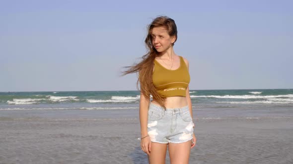 Sexy Young Girl with Long Hair Standing on the Beach alt