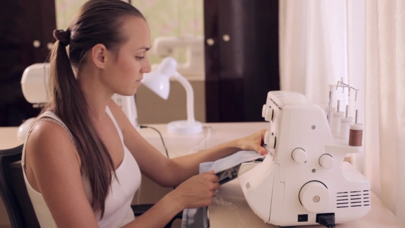 Beautiful Woman Sews. Powered By Overlock. alt