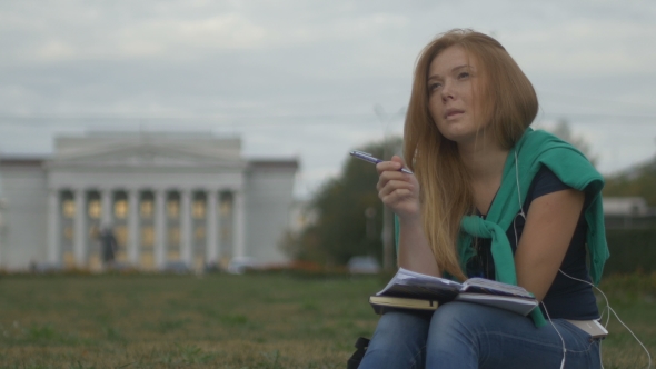 Student Makes Notes In a Notebook alt
