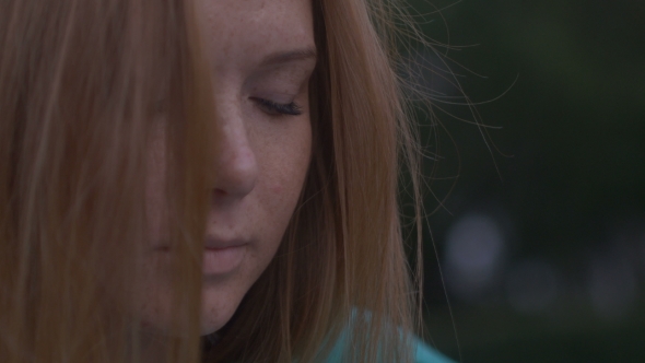 Girl Sits Musingly On The Grass alt