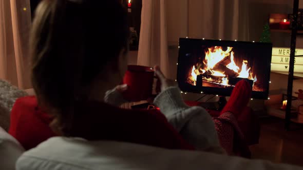 Woman Drinking Coffee at Home on Christmas alt