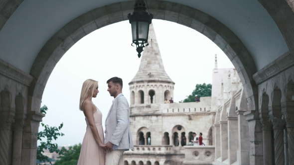 Luxury Couple Hugging And Kissing On The Background Of White Magnificent Ancient Castle