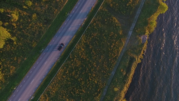 Aerial View To Cliff, Sea And Car Driving On Road 12 alt