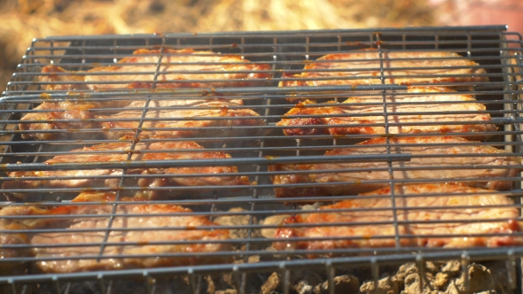 Grilled Pork Steaks Over Flames And Coals, On The Brazier alt