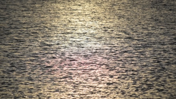 Water Surface of Sea at Dawn With Reflection of Sun Light