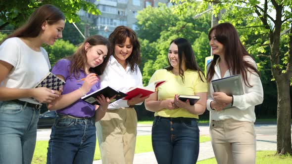 Happy Teens Girls Studying Together Outdoors Enjoying Life alt