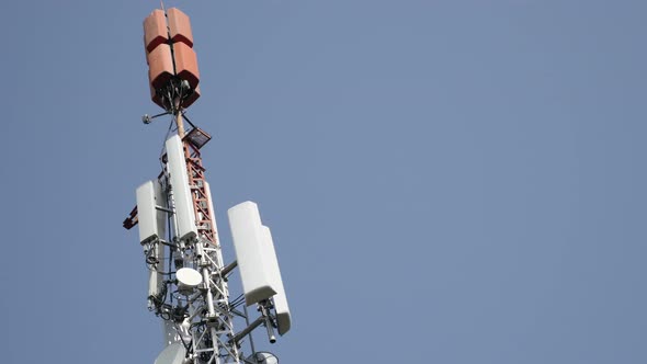 Base station  for mobile and television communication against blue sky 4K 2160p 30fps UHD footage -  alt