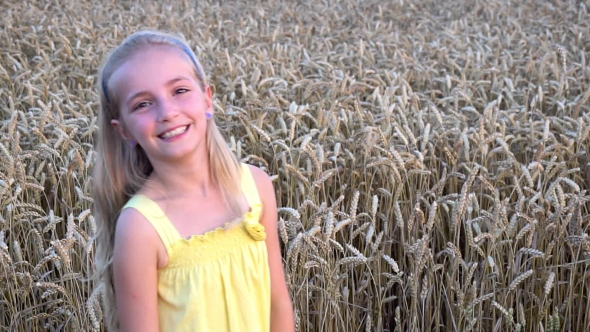 Cute Girl In Wheat Field