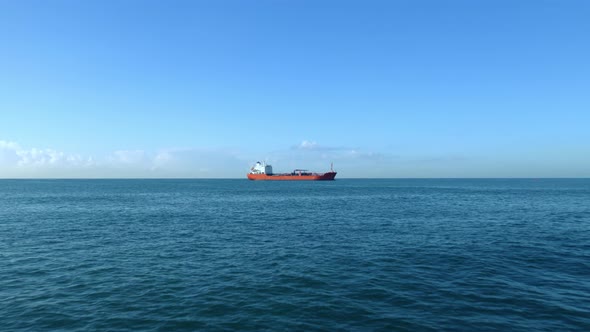 Cargo Ship On The Horizon Of The Sea
