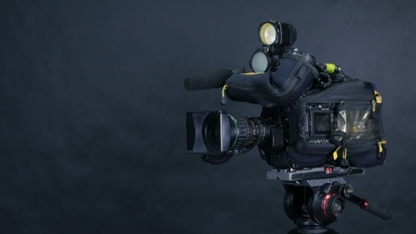 Professional Digital Video Camera, Camcoder Isolated On Black Background In Tv Srudio. alt