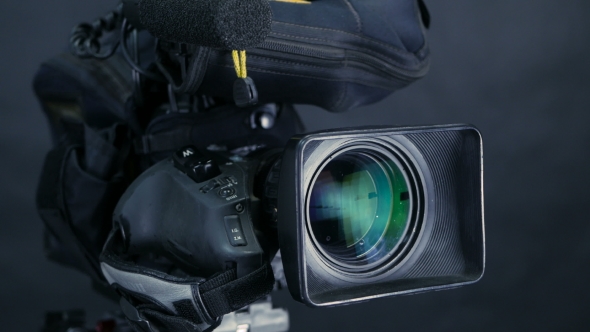 Movement Along Professional Studio Camera, Camcoder Standing In TV Studio Ready For Broadcasting. alt
