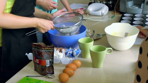 Unrecognizable Woman Sifting Flour Using a Sieve alt