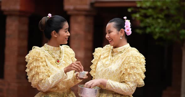 Young beautiful women enjoy to splashing water on Songkran festival alt