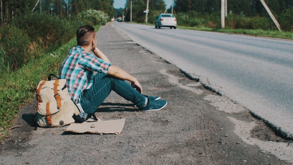 Man Sit At Road In Countryside