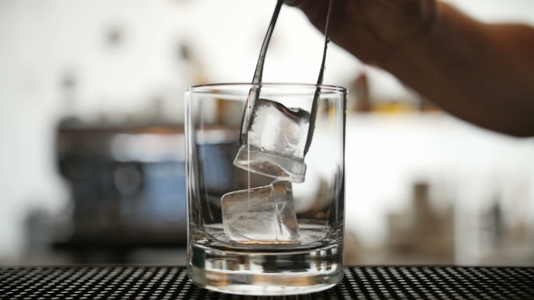 Pouring Ice In a Glass