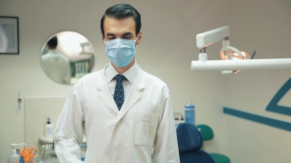 Dentists Man Take Of Mask And Smiling