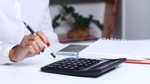 People In The Office Doing Calculations And Writes It In a Notebook.  alt