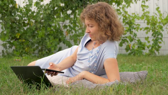 Lady with notebook working outdoor, Office outdoor, Working with notebook on fresh air