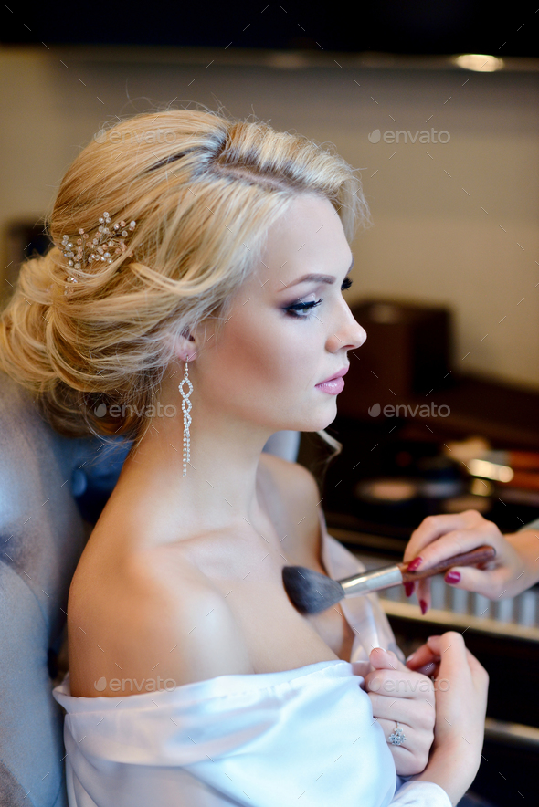 Wedding makeup artist making a make up for bride - Stock Photo - Images