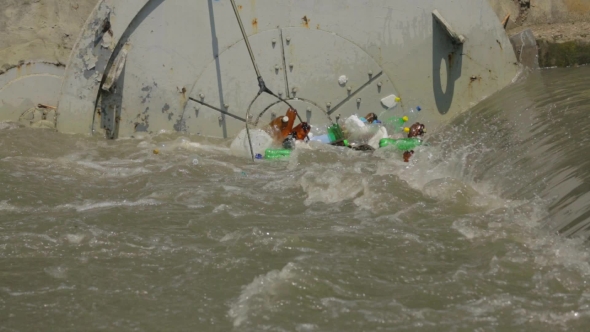 People Cleaning Polluted River With Net