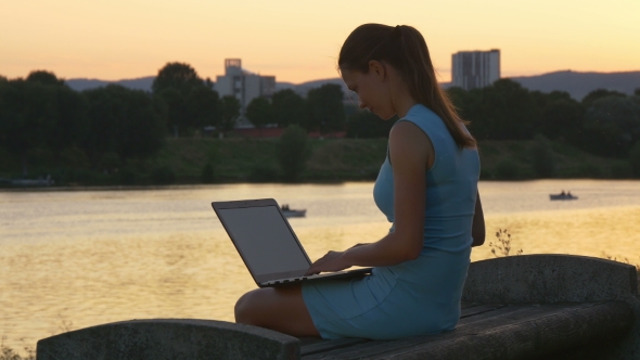 Woman In An Evening Dress With Laptop