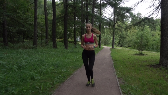 Young Woman Jogging In The Park