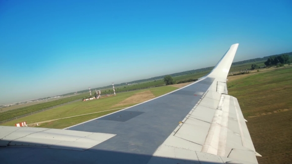 Aircraft Wing Window View While Airplane Taking Off From Airport