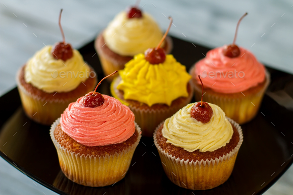 Bright cupcakes with cherries